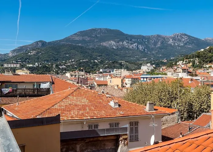 Between The Roofs Of Menton Old Town And The Sea