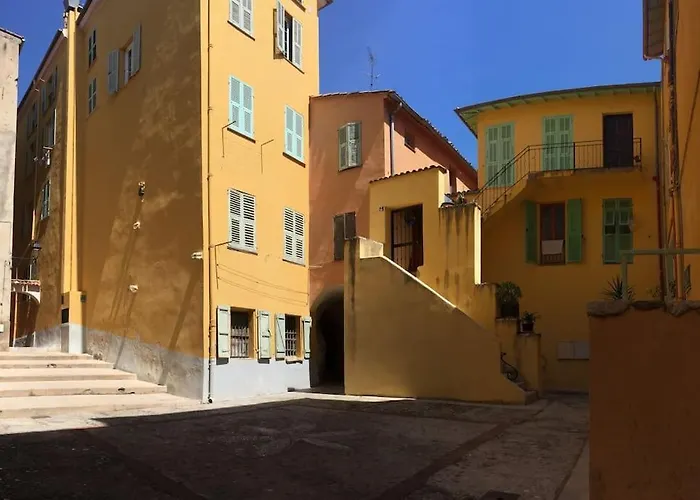 Between The Roofs Of Menton Old Town And The Sea